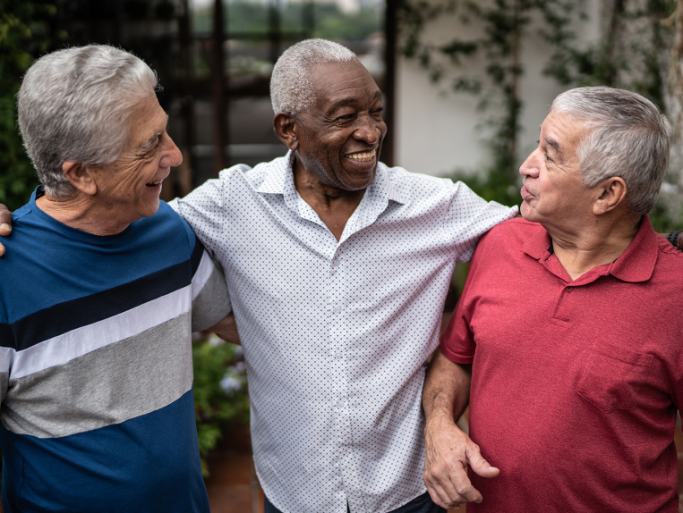 Group of male seniors hugging eachother