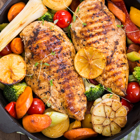 two pieces of grilled chicken with a harvest blend of veggies