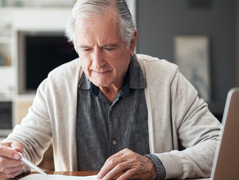 senior man reviewing his bank statements