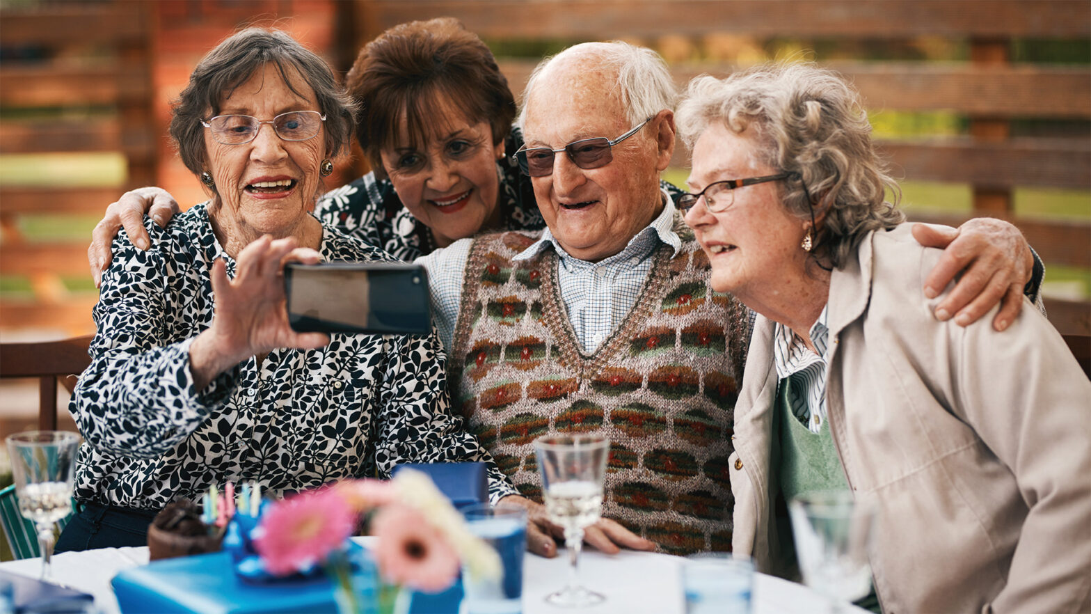 Senior friends taking a selfie at dinner time in the dining roomSenior friends taking a selfie at dinner time in the dining room
