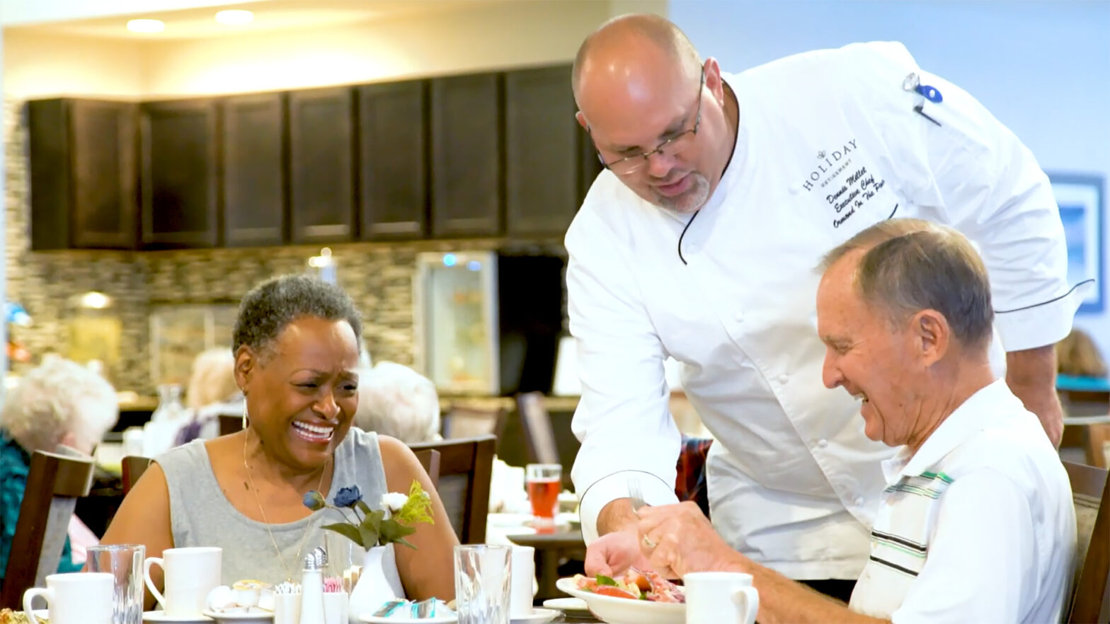 Chef serving senior residents a meal