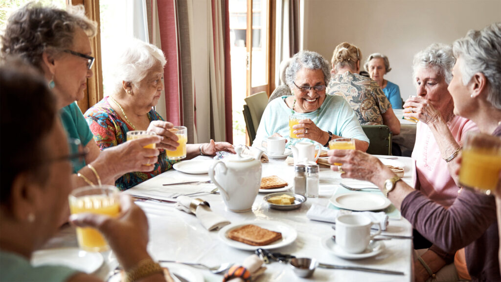 Seniors getting having dinner together in the dining room