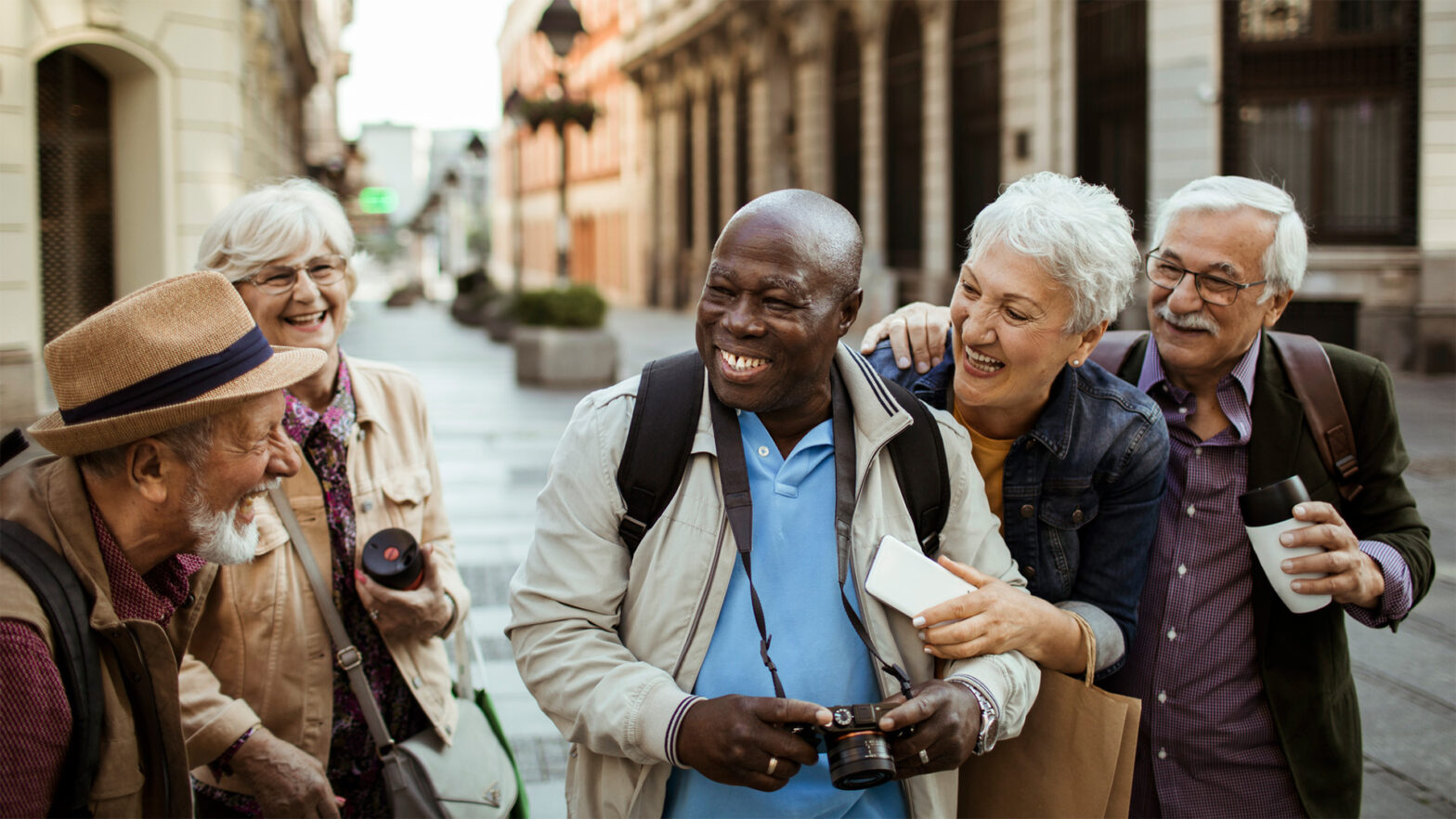 Group of seniors traveling together and touring a city overseas.