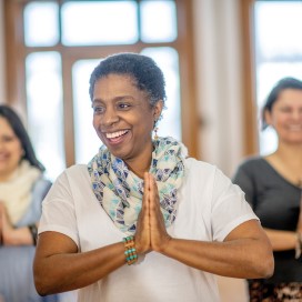 senior black woman doing yoga