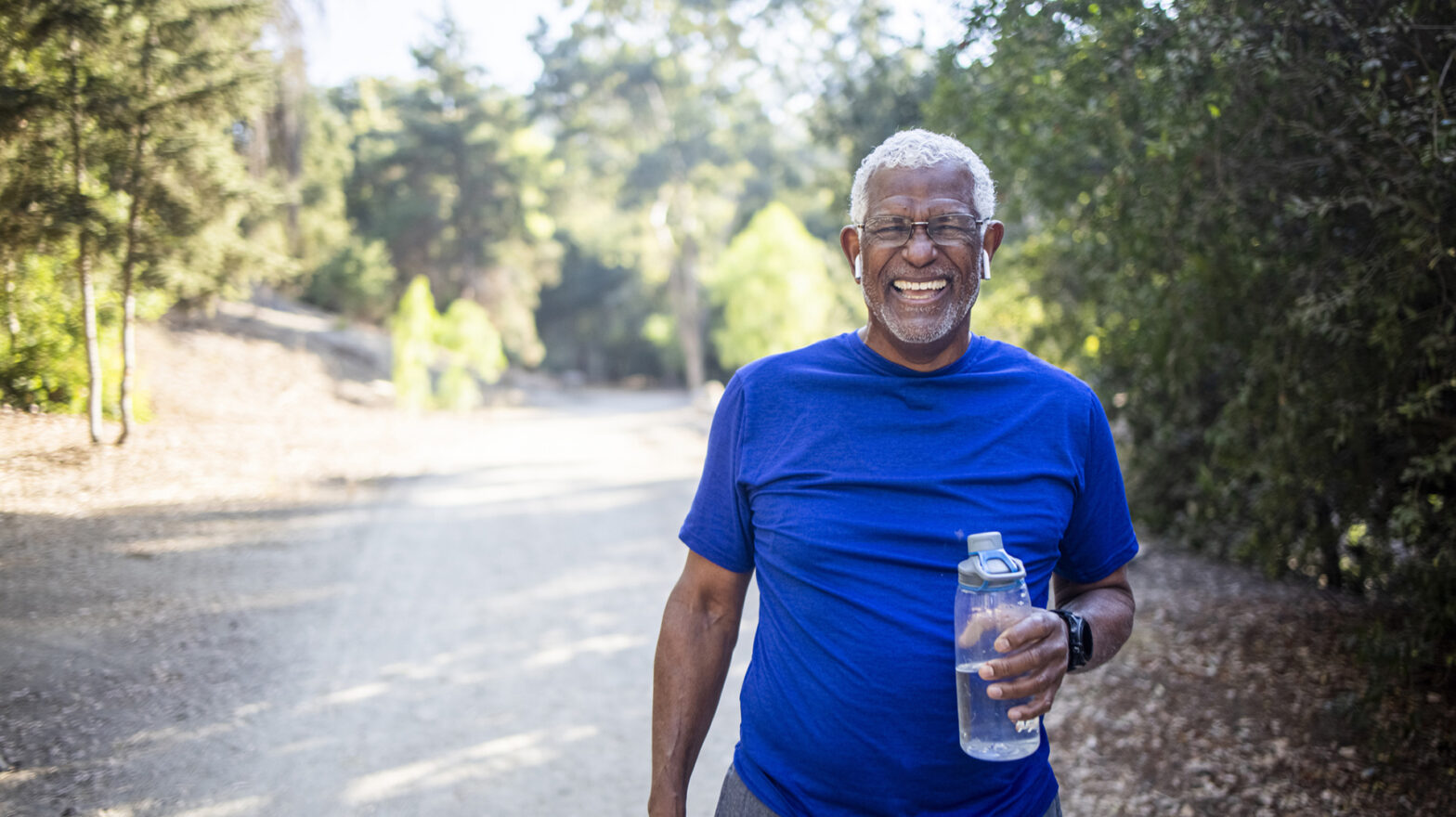 A senior African American Man enjoying refreshing water after a workout