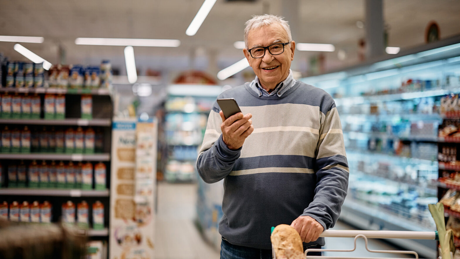 Senior man walking in grocery store