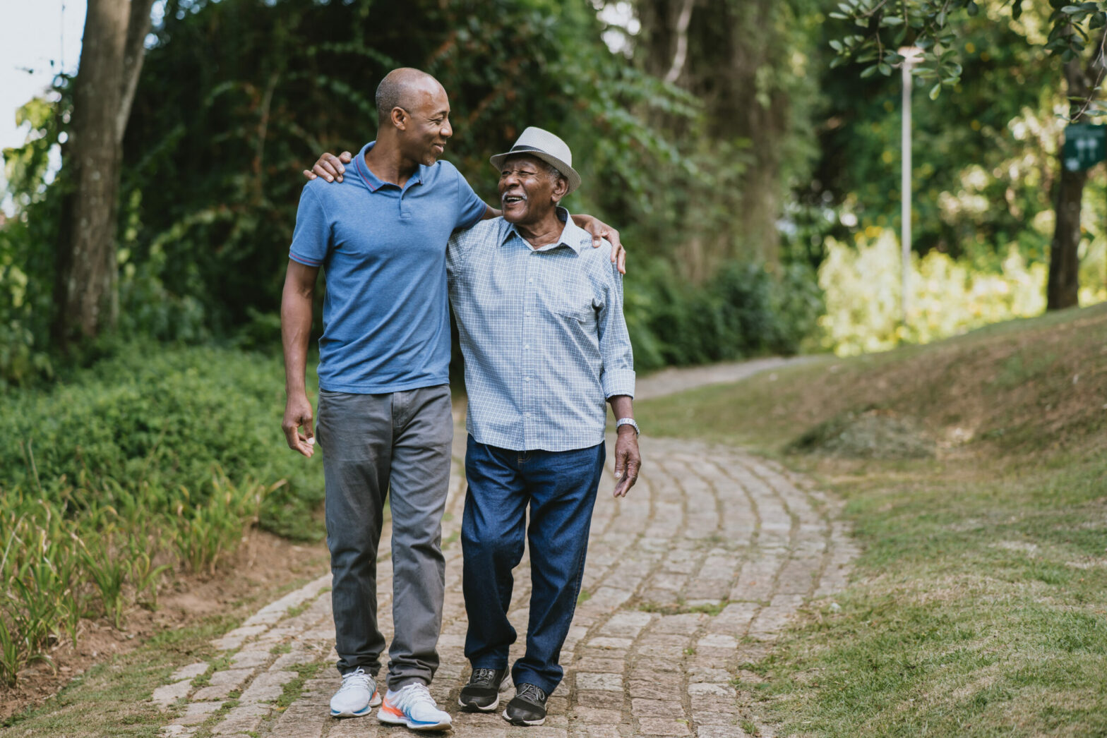 Portrait of elderly father and adult son walking