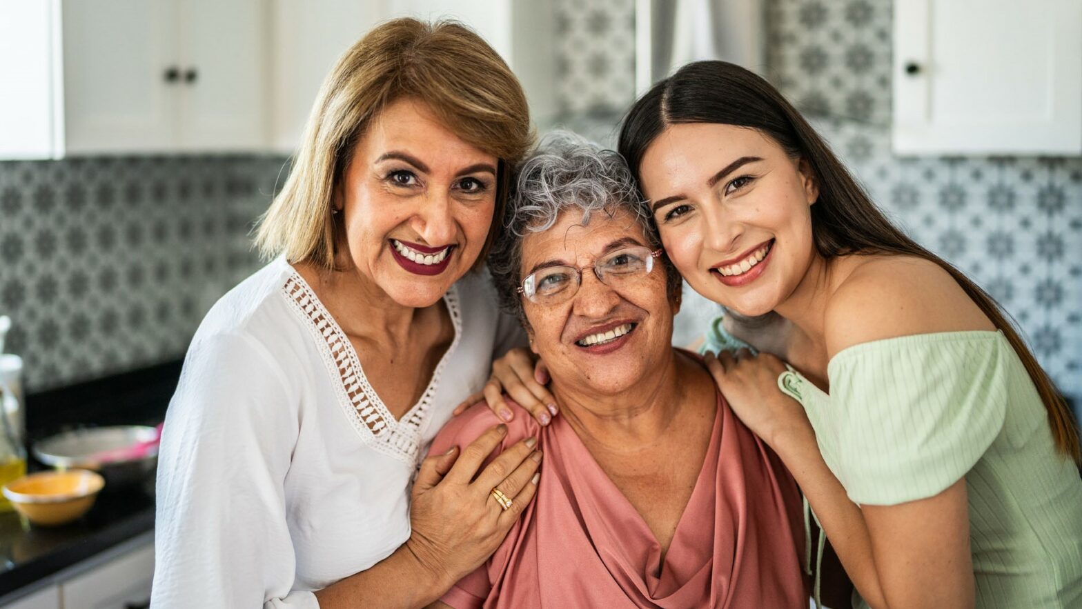 Portrait of family embracing in the kitchen at home