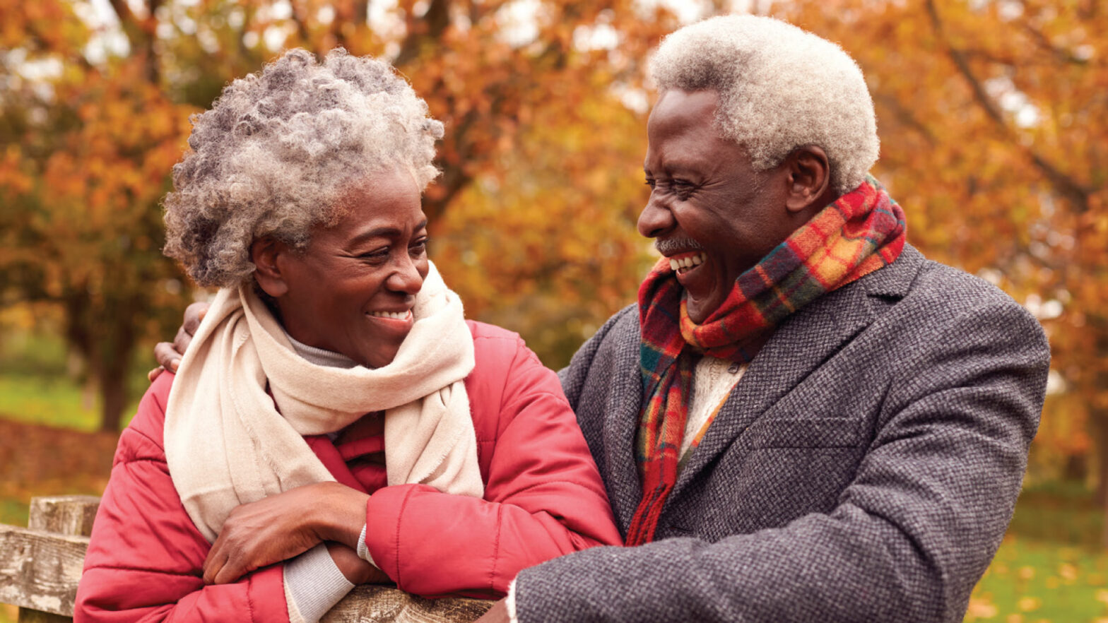 Senior woman and man walking in the fall