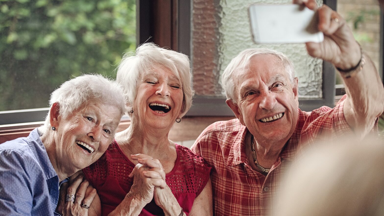 Good old friends having great times together during a summer day in a gazebo.