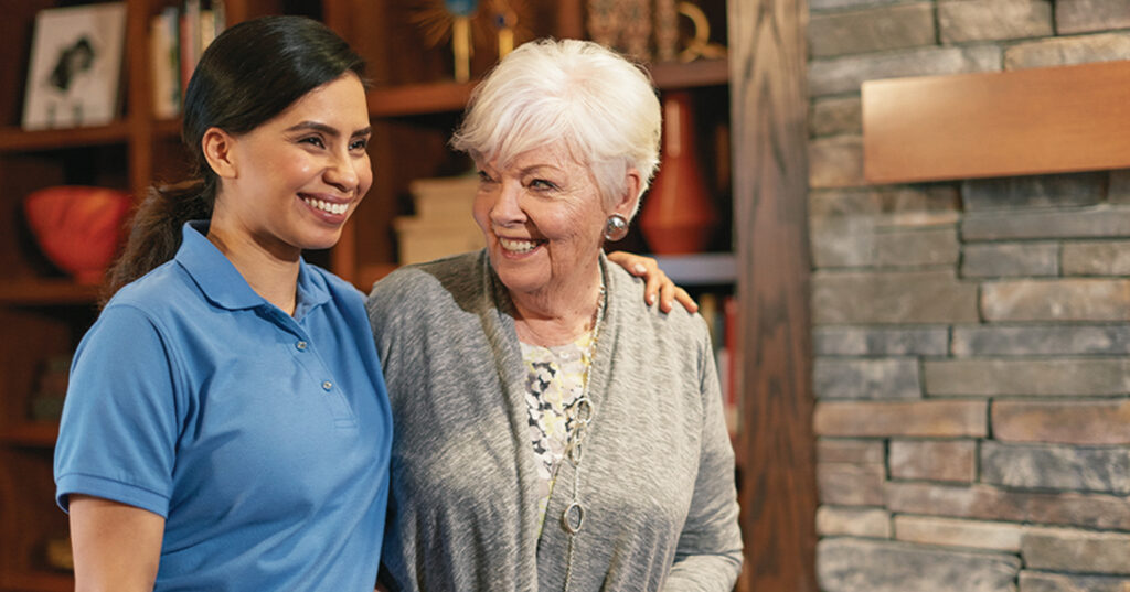 Atria Senior Living resident and employee walking together