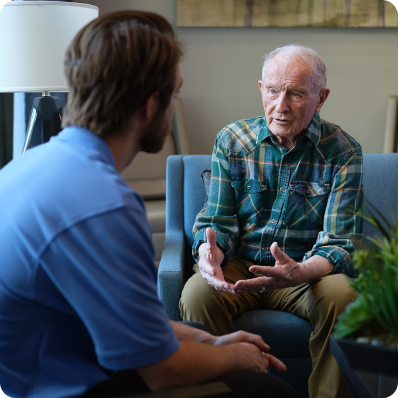Older man talking with a Atria employee