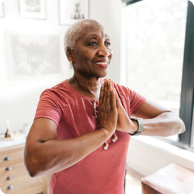 Senior woman doing yoga in her apartment