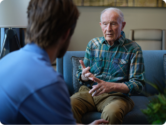 Older man talking with a Atria employee