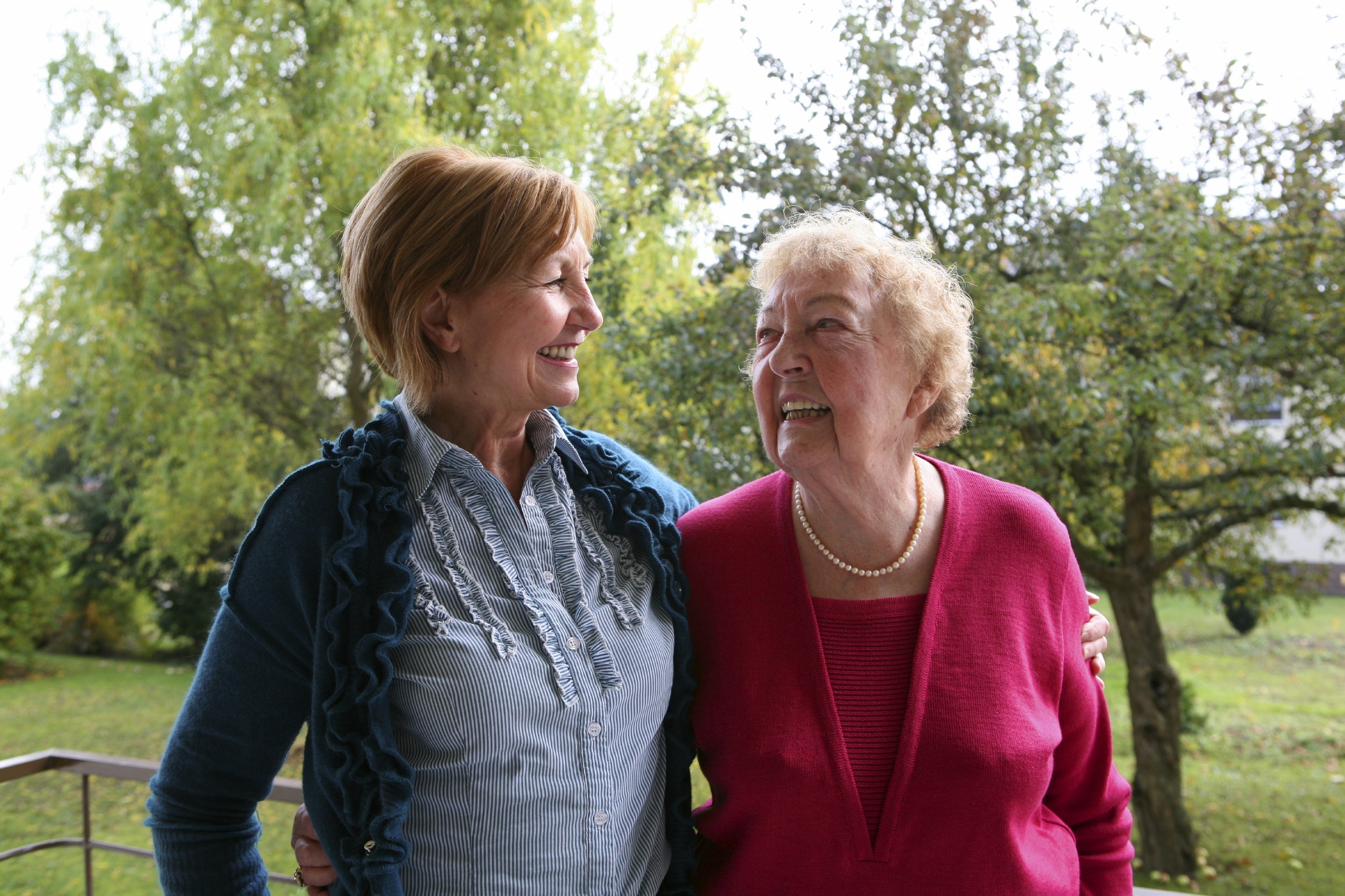 Older woman and her daughter standing together