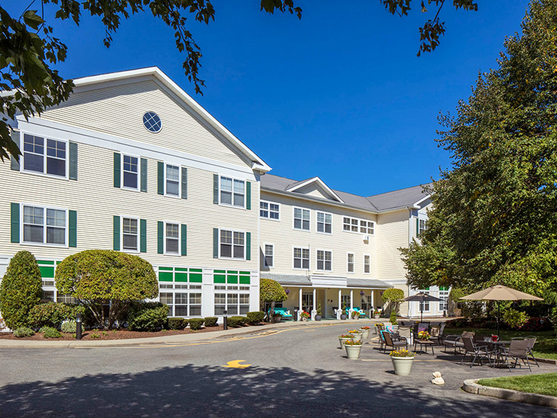 Exterior entrance and seating area at Atria Lincoln Place Senior Living